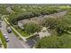 Aerial view of two homes in a neighborhood with mature trees and well-manicured lawns at 9031 Stonebury Way, Orlando, FL 32832