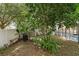 Backyard view of garden with grilling area and pool in the distance at 9031 Stonebury Way, Orlando, FL 32832