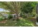 Backyard view of garden with lush landscaping and white fence at 9031 Stonebury Way, Orlando, FL 32832