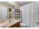 Bathroom featuring a vanity with framed mirror and shower with white curtain at 9031 Stonebury Way, Orlando, FL 32832