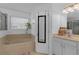 Relaxing bathroom features a soaking tub, natural light, and a vanity with storage at 9031 Stonebury Way, Orlando, FL 32832