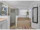 Bright bathroom featuring a large soaking tub, glass enclosed shower and tile flooring at 9031 Stonebury Way, Orlando, FL 32832
