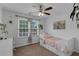 Bright bedroom with a ceiling fan, desk and a cozy daybed with storage drawers at 9031 Stonebury Way, Orlando, FL 32832