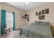 Comfortable bedroom with wood-look floors and teal curtains at 9031 Stonebury Way, Orlando, FL 32832
