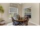 Cozy dining area with wooden table set, natural light and views from the windows at 9031 Stonebury Way, Orlando, FL 32832