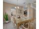 Elegant dining room showcasing a glass table, staircase, and neutral color palette at 9031 Stonebury Way, Orlando, FL 32832