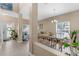 Sunlit dining room featuring a large table and views of the landscaped yard at 9031 Stonebury Way, Orlando, FL 32832