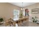 Spacious dining room with a glass table, plants, and natural light at 9031 Stonebury Way, Orlando, FL 32832