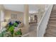 Inviting entryway showcases the staircase, with views of the dining room and cozy living area at 9031 Stonebury Way, Orlando, FL 32832