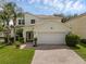 Charming two-story home with a well-maintained lawn and a brick paved driveway at 9031 Stonebury Way, Orlando, FL 32832