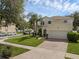 Beautifully landscaped two-story home with a brick paved driveway and a two car garage at 9031 Stonebury Way, Orlando, FL 32832