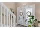 Welcoming foyer features decorative glass front door and staircase to the second floor at 9031 Stonebury Way, Orlando, FL 32832