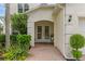 Charming front entrance with brick walkway, double doors, and lush landscaping at 9031 Stonebury Way, Orlando, FL 32832