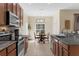 Modern kitchen featuring stainless steel appliances, granite countertops, and an eat-in dining area at 9031 Stonebury Way, Orlando, FL 32832