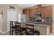 Stylish kitchen with a granite countertop bar, stainless appliances, and pendant lighting at 9031 Stonebury Way, Orlando, FL 32832