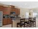 Modern kitchen featuring stainless steel appliances, granite countertops, and breakfast bar seating at 9031 Stonebury Way, Orlando, FL 32832