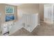 Upper landing offers a bright, carpeted space with views to the front entryway and a nearby bathroom at 9031 Stonebury Way, Orlando, FL 32832