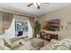 Comfortable living room featuring stylish furniture, a large TV, and sliding glass doors to the pool at 9031 Stonebury Way, Orlando, FL 32832