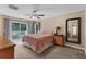 Relaxing main bedroom with balcony access, a cozy bed, and a traditional dresser at 9031 Stonebury Way, Orlando, FL 32832