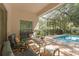 Screened in patio with comfortable seating and a view of the pool area at 9031 Stonebury Way, Orlando, FL 32832