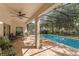 Covered patio with outdoor seating area overlooks the screened-in pool at 9031 Stonebury Way, Orlando, FL 32832