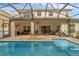 Inviting backyard pool with screened-in patio area ideal for outdoor lounging at 9031 Stonebury Way, Orlando, FL 32832