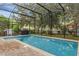 Backyard view of the screened-in pool with outdoor kitchen area at 9031 Stonebury Way, Orlando, FL 32832