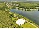 Panoramic aerial view of a community lake with walking trails and volleyball court at 9997 Town Lake Dr, Orlando, FL 32832