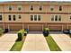 Aerial view of townhomes with garages and small manicured lawns at 9997 Town Lake Dr, Orlando, FL 32832
