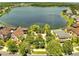 Aerial view of the community featuring homes surrounded by tropical plants and trees around a peaceful lake at 9997 Town Lake Dr, Orlando, FL 32832