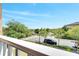 Balcony view showing the lush neighborhood, street, and a glimpse of a serene pond at 9997 Town Lake Dr, Orlando, FL 32832
