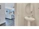 Upstairs bathroom area with a pedestal sink, mirror, and views into the living room at 9997 Town Lake Dr, Orlando, FL 32832