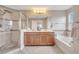 Bright bathroom featuring double sinks, a bathtub, and glass enclosed shower at 9997 Town Lake Dr, Orlando, FL 32832