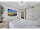 Bedroom with mounted TV and door to hall and closet at 9997 Town Lake Dr, Orlando, FL 32832