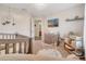 Bedroom with gray crib, changing table and chandelier at 9997 Town Lake Dr, Orlando, FL 32832