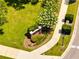 Aerial view of the Ravinia East Park community sign, landscaped with green grass and a flowering tree at 9997 Town Lake Dr, Orlando, FL 32832