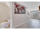 Bright entryway featuring gray tile floors, a staircase, and a world map art piece at 9997 Town Lake Dr, Orlando, FL 32832