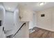 Bright hallway with wood floors, white walls, and access to the second floor at 9997 Town Lake Dr, Orlando, FL 32832
