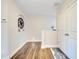 Hallway with wood floors featuring a decorative wagon wheel wall hanging at 9997 Town Lake Dr, Orlando, FL 32832