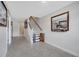 Clean and spacious hallway with tile flooring, stairs to the upper level, and modern decor at 9997 Town Lake Dr, Orlando, FL 32832