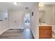 Hallway with wood floors, storage closet, and access to a bathroom and bedroom at 9997 Town Lake Dr, Orlando, FL 32832