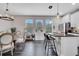 Well-lit kitchen and dining area with stainless steel appliances, a kitchen island, and plants at 9997 Town Lake Dr, Orlando, FL 32832