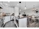 Kitchen and dining area with stone countertops, stainless steel appliances, and great lighting at 9997 Town Lake Dr, Orlando, FL 32832