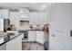 Bright kitchen with stainless steel appliances, stone countertops and backsplash, and white cabinetry at 9997 Town Lake Dr, Orlando, FL 32832