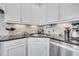 Close-up of a granite countertop with stainless steel sink, white cabinetry, and modern decor at 9997 Town Lake Dr, Orlando, FL 32832