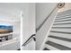 Living room and staircase with white walls and wood-look stair treads at 9997 Town Lake Dr, Orlando, FL 32832