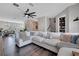 Open-concept living area with comfortable sectional sofa and dark hardwood floors at 9997 Town Lake Dr, Orlando, FL 32832