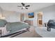 This carpeted main bedroom has neutral walls, tv, ceiling fan and ensuite bath at 9997 Town Lake Dr, Orlando, FL 32832