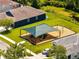 Aerial view of a playground area, complete with a sunshade, slide, and swings at 9997 Town Lake Dr, Orlando, FL 32832
