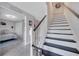 Modern staircase with white risers and dark stained steps leading to the upper level at 9997 Town Lake Dr, Orlando, FL 32832